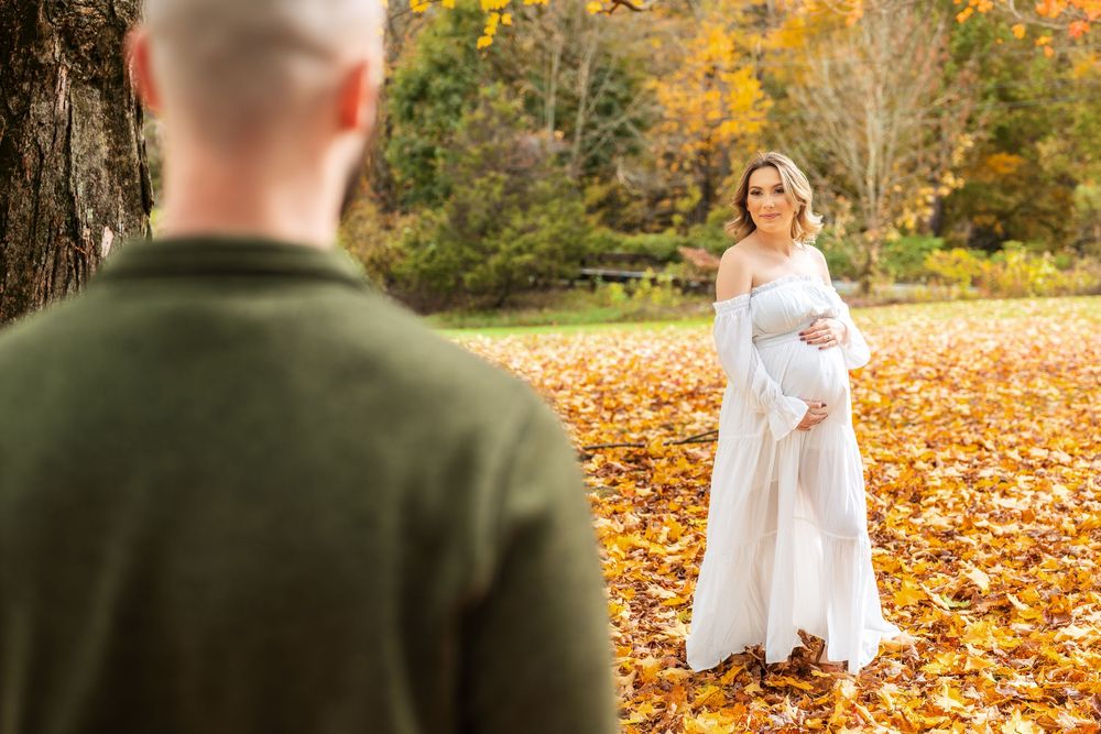 A romantic photoshoot among autumn trees with bright yellow foliage.