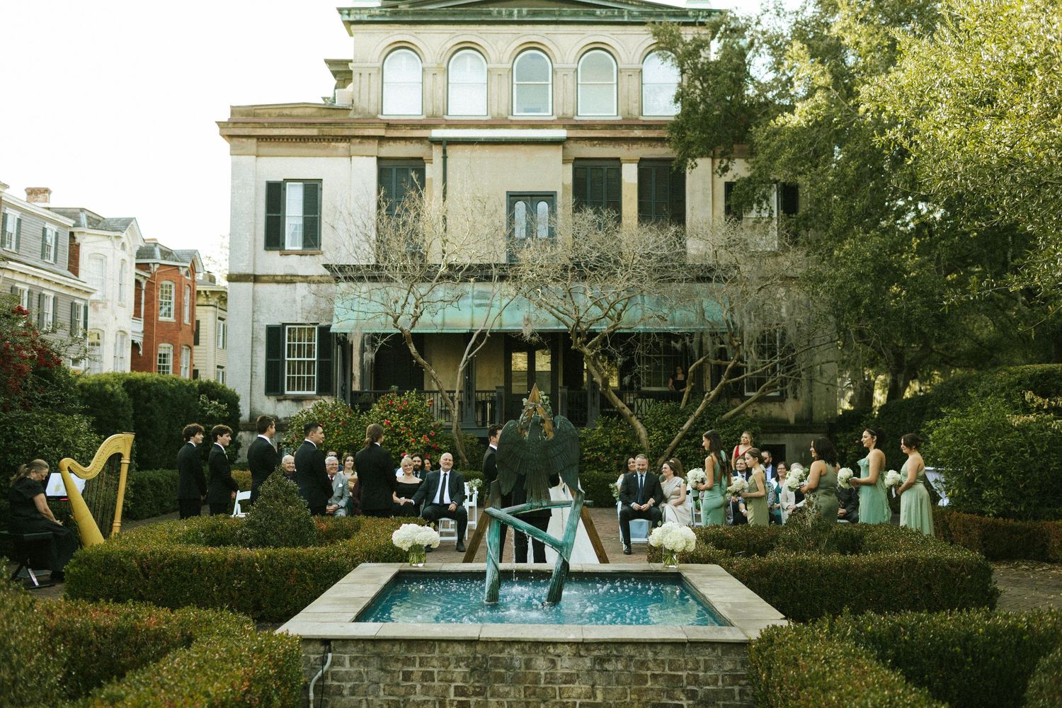 A winter wedding ceremony held in the courtyard of the Harper Fowlkes House in Savannah, GA