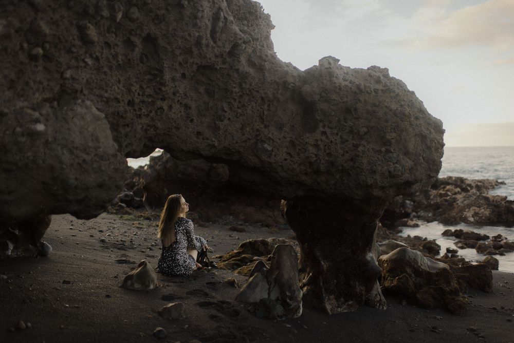 Scenic panoramic view of rocky coastline with dramatic cliffs and crashing waves at sunset.