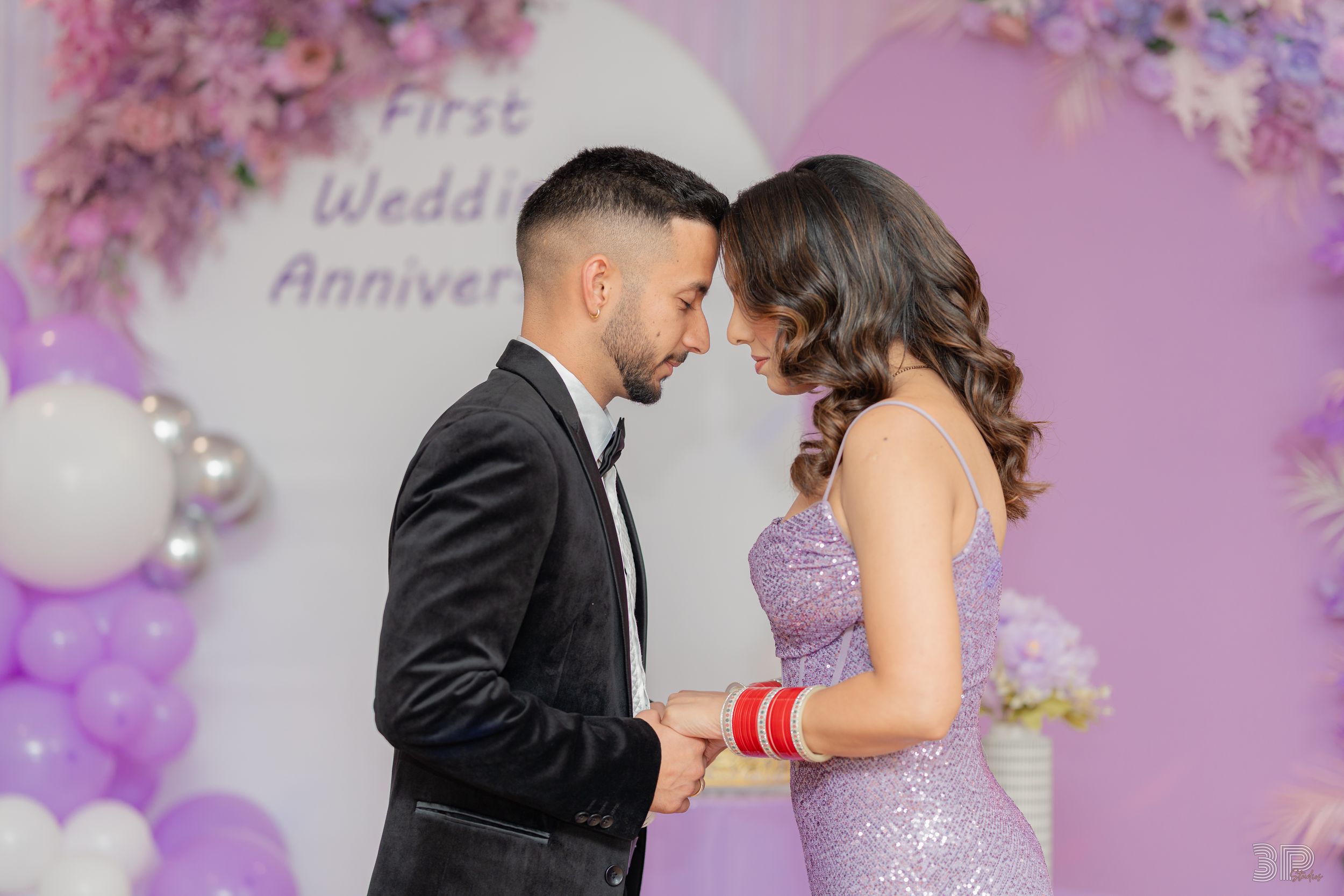 A romantic wedding photo collage with purple balloon decorations and floral arrangements in the background.