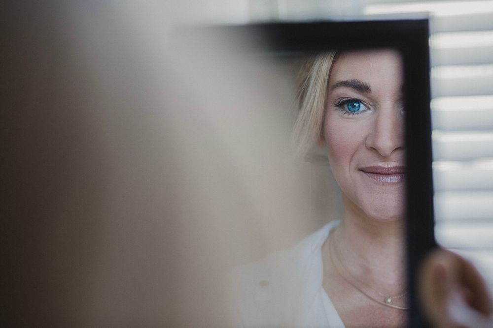 A close-up view through window blinds capturing a soft, artistic portrait in natural light.