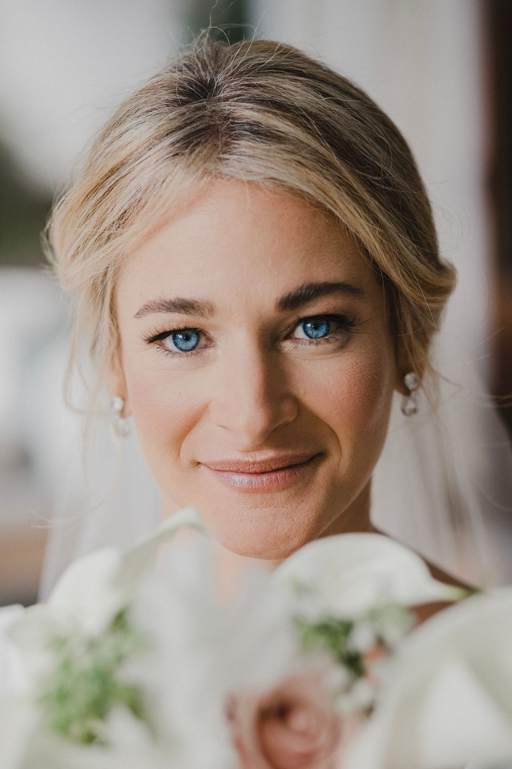 Intimate bridal portrait with soft lighting and natural makeup.