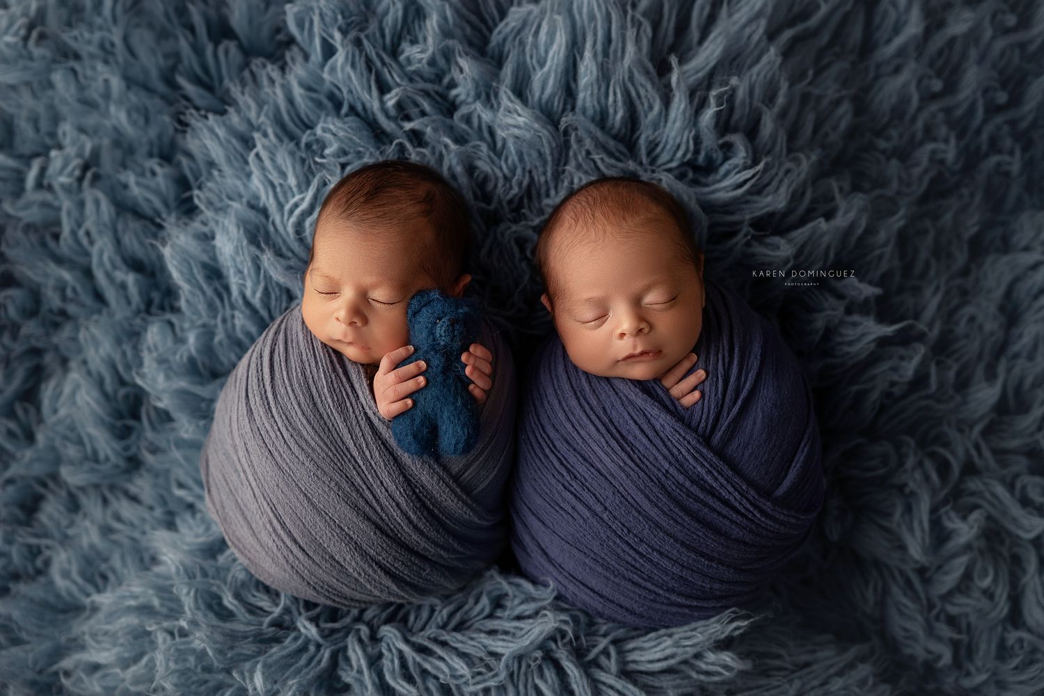 A series of newborn photography shots showing sleeping babies wrapped in cozy blue and gray blankets on soft textured backgrounds.