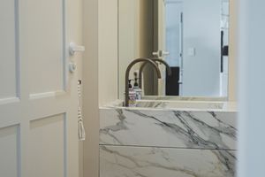 Luxurious bathroom featuring marble countertops and modern faucet fixtures.