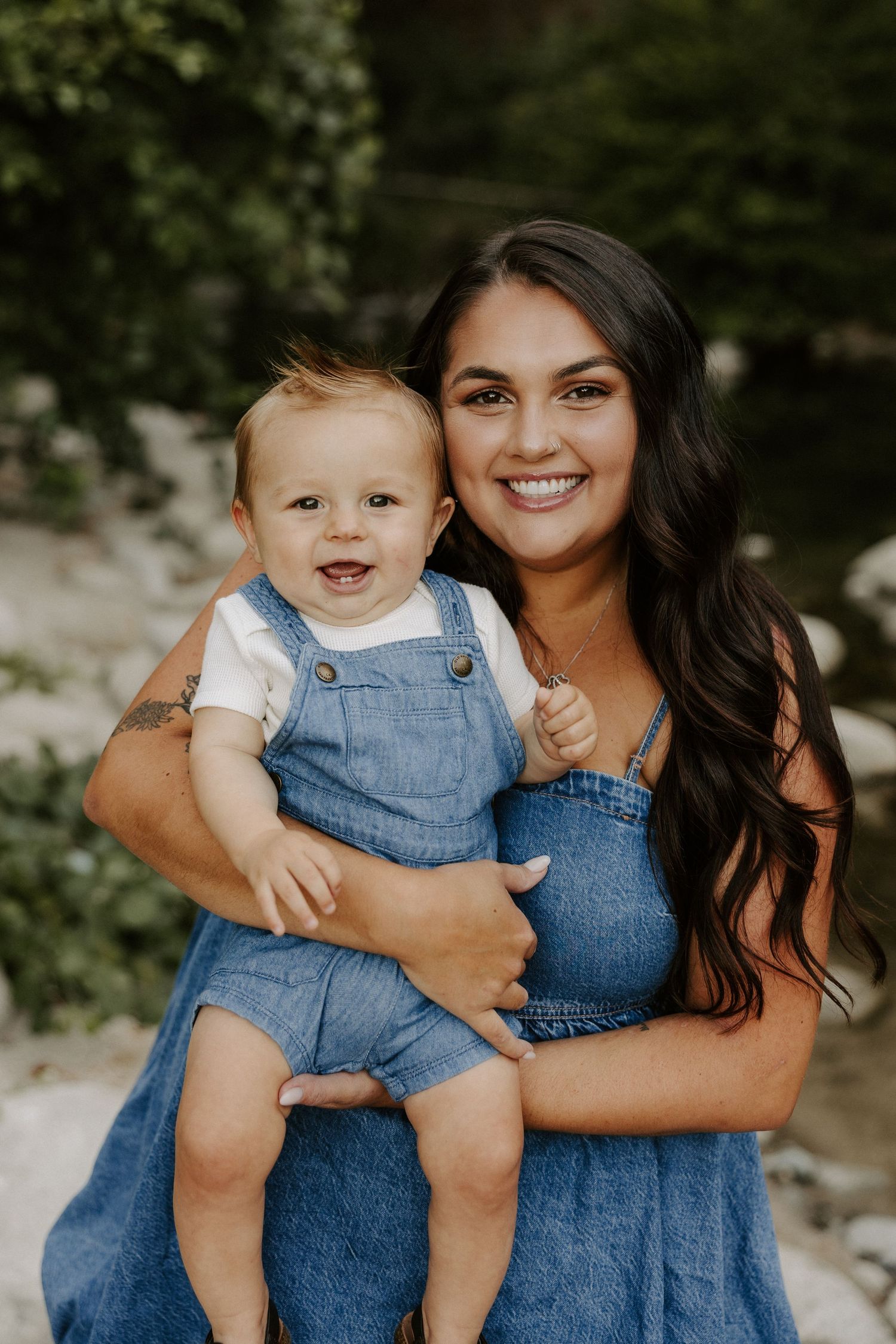 A series of outdoor family portraits showing tender moments between parent and child in matching denim outfits.