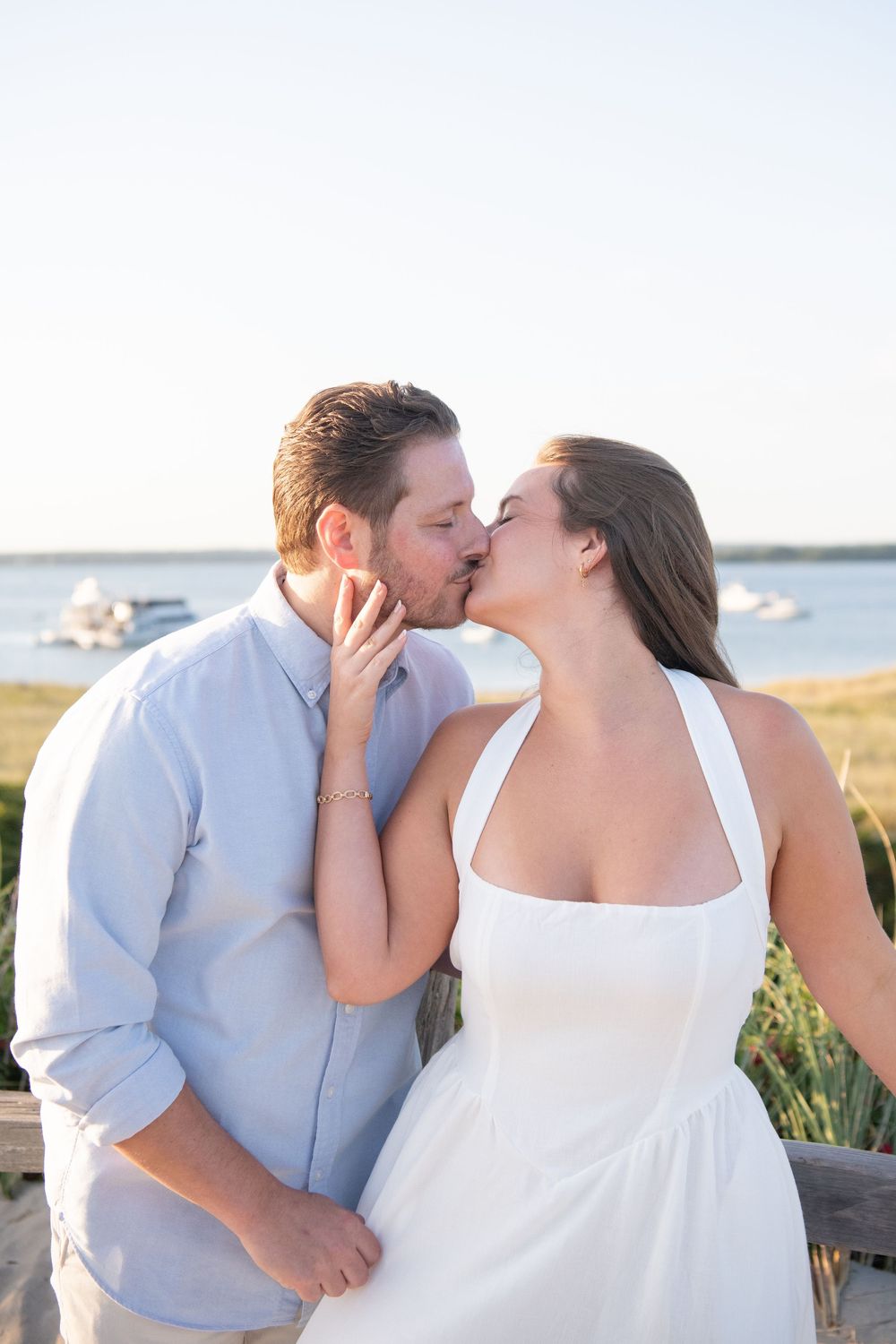 Tender moments captured between couple during coastal sunset photoshoot.