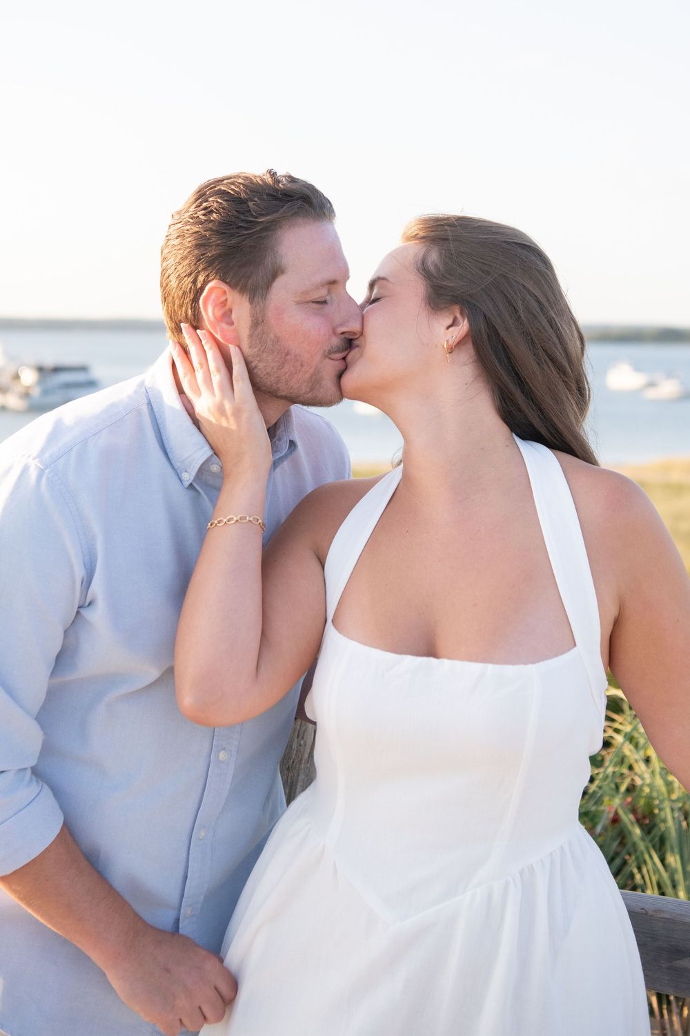 Intimate coastal portrait series showing couple's loving embrace.