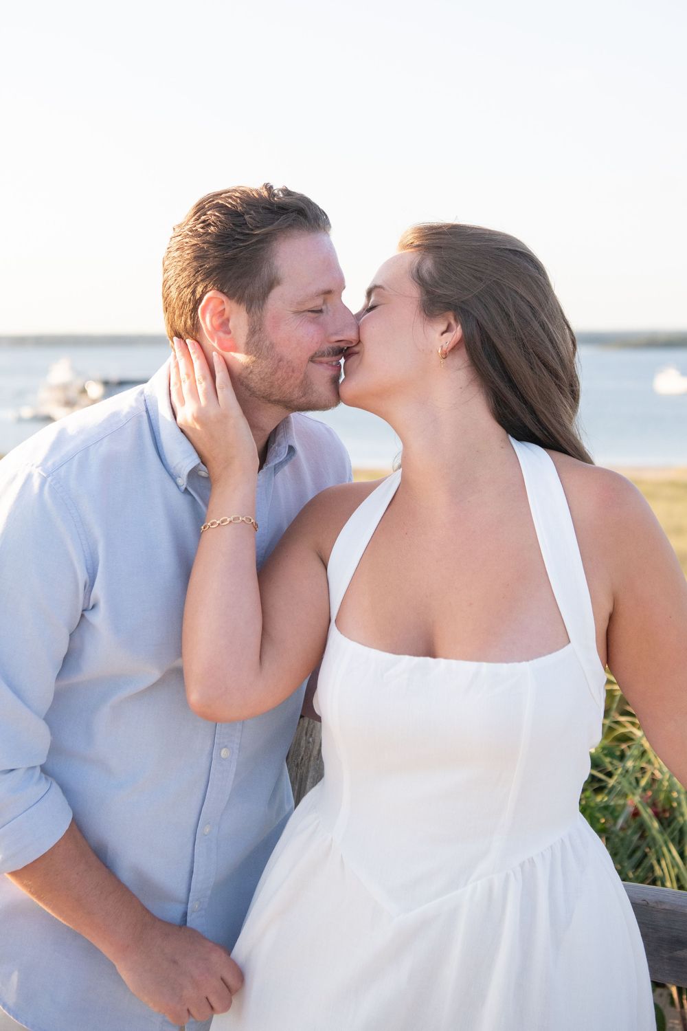 Sweet candid moments between couple during beach sunset photo session.