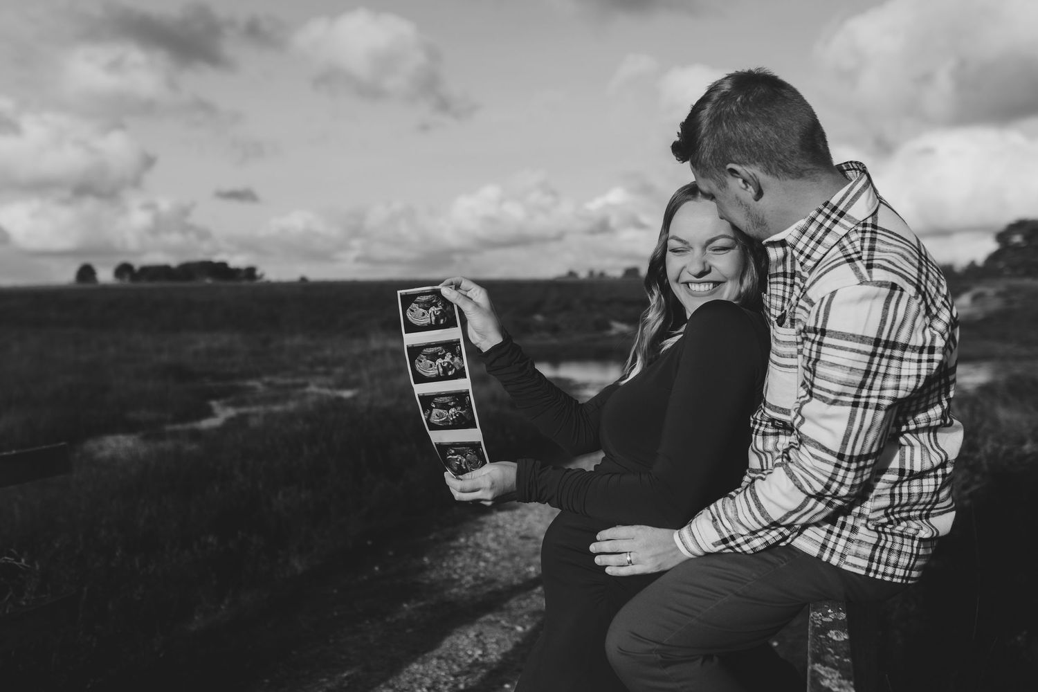 Pregnant couple together in the New Forest, enjoying a quiet, natural moment together.
