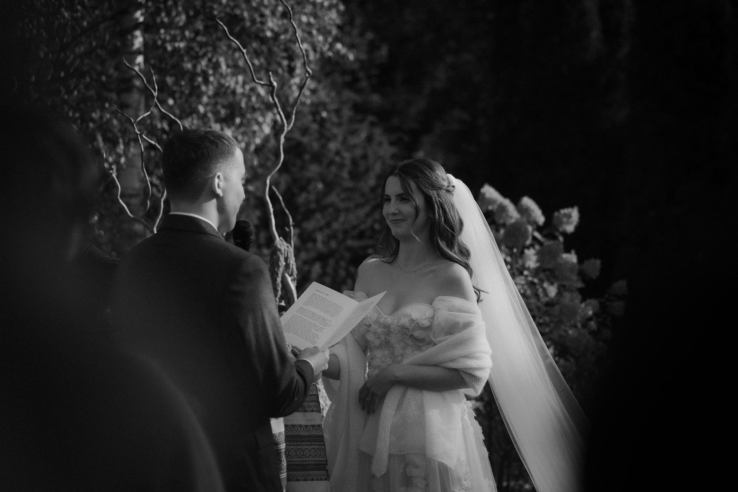 Black and white wedding photo series showing intimate moments between a bride and groom during their special day.