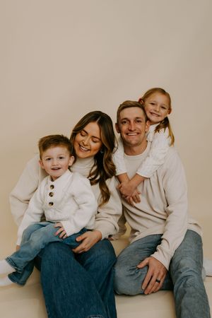 Casual studio family session showing genuine smiles and laughter.