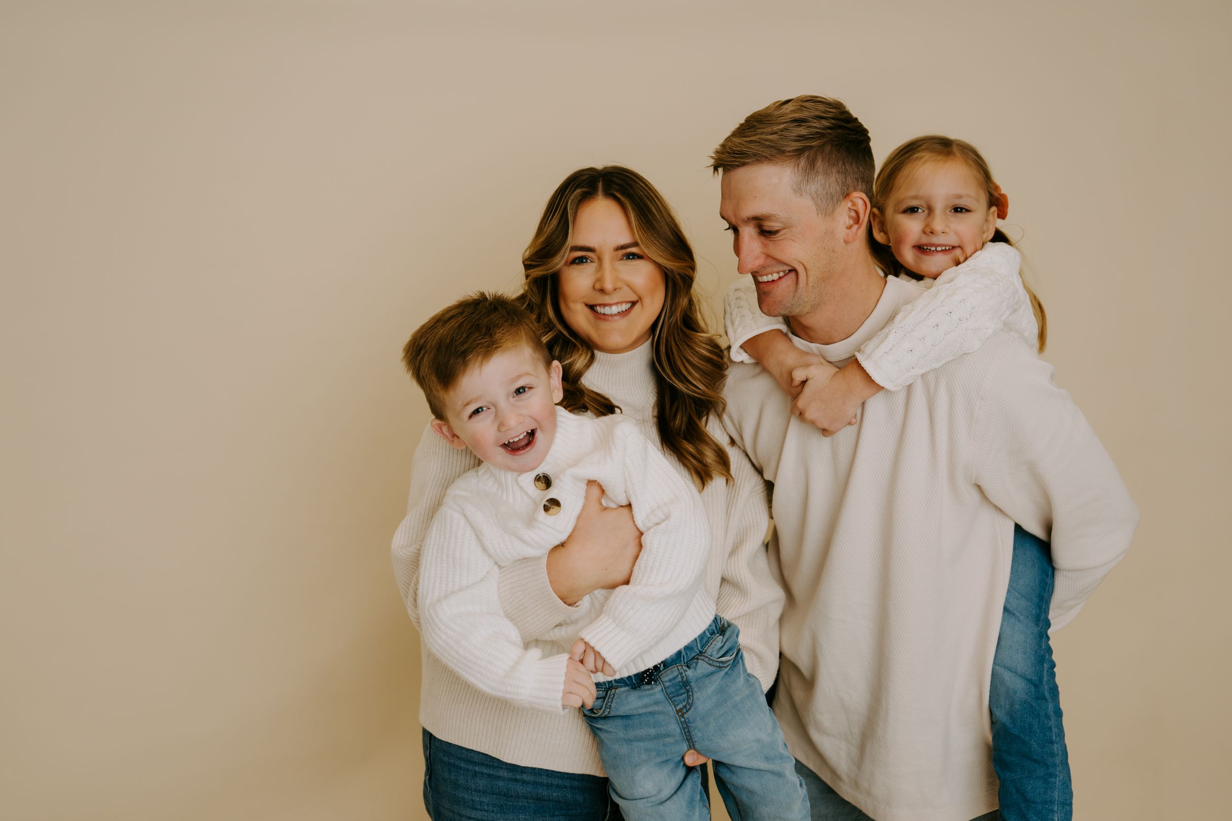 Modern family photography session featuring natural expressions and coordinated casual attire.