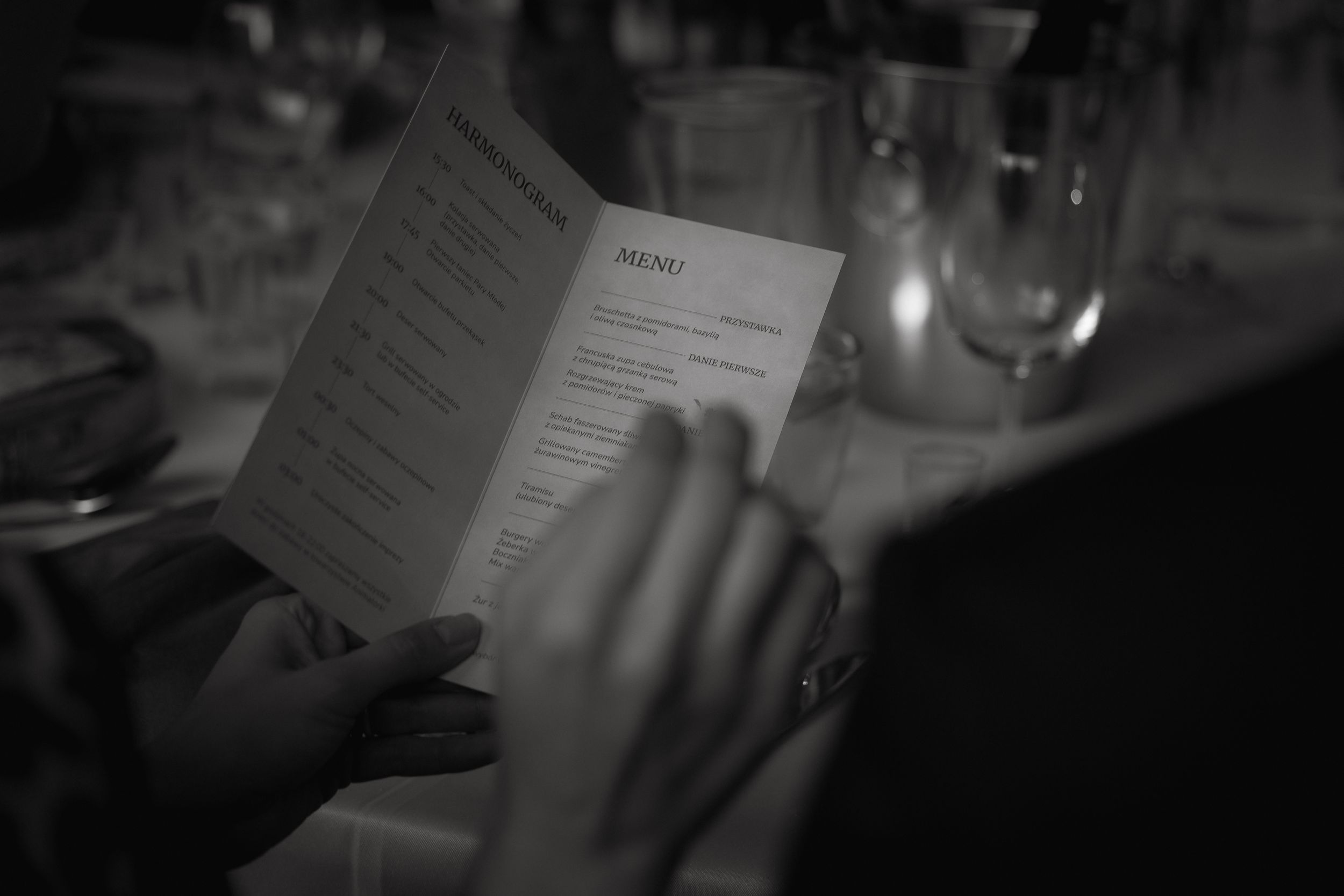 A series of black and white photos showing hands turning pages in a book under dim lighting.