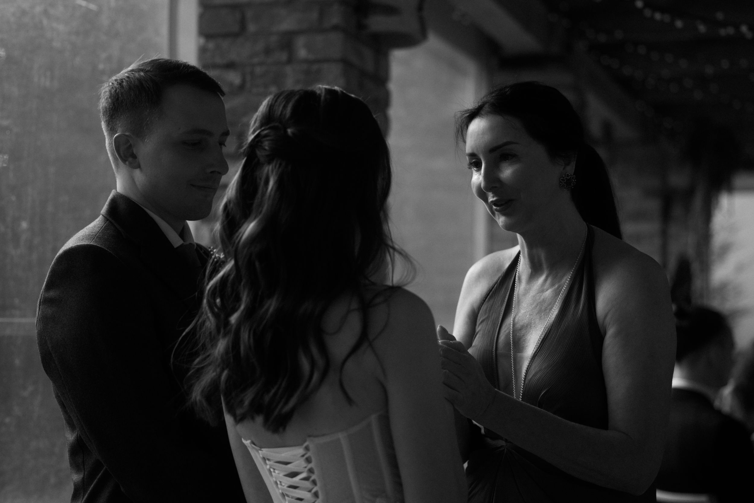 A black and white photo series showing couples dancing and embracing at a romantic wedding celebration.