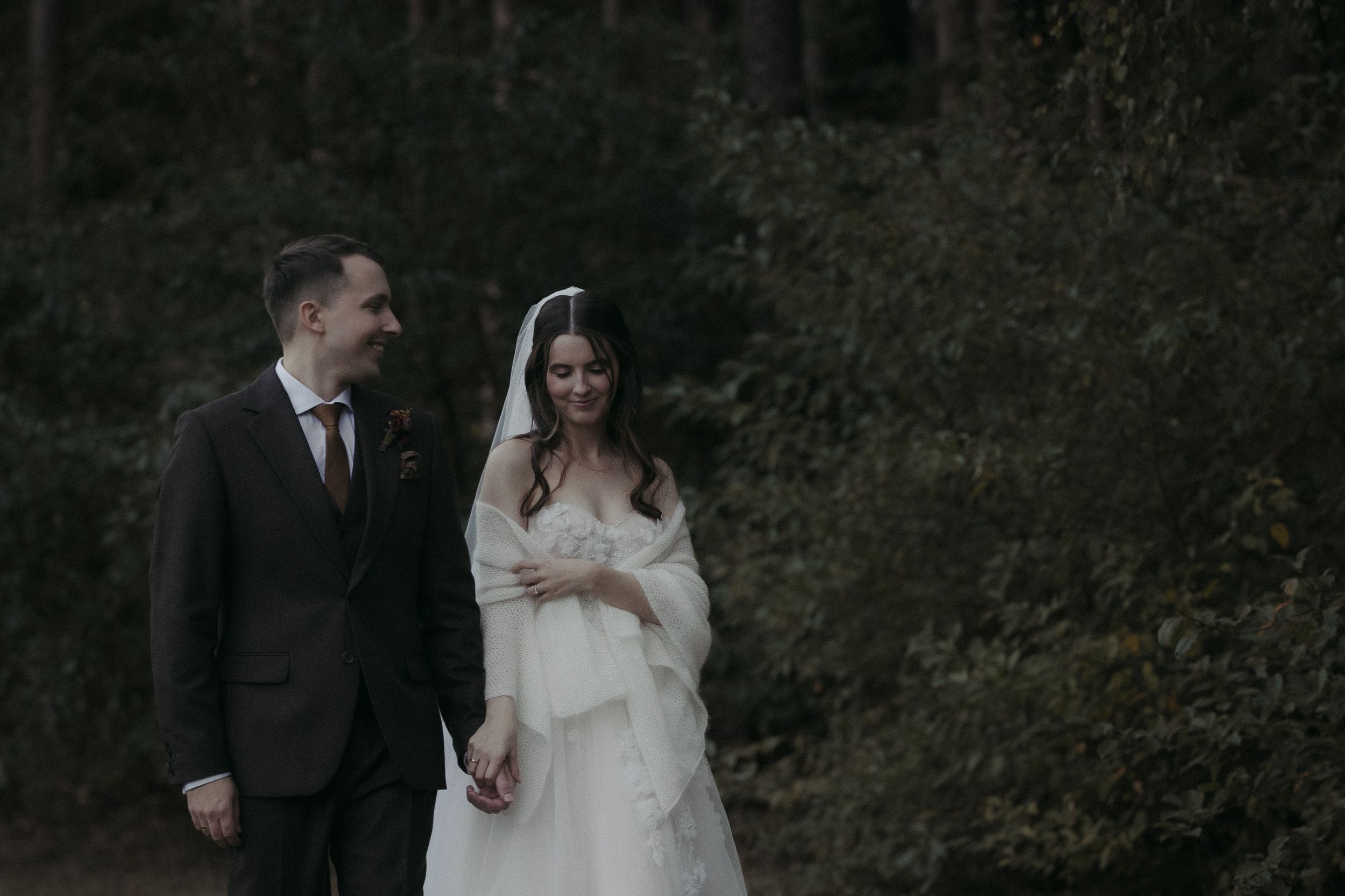 Black and white wedding photos capturing intimate moments between couples in an outdoor garden setting.