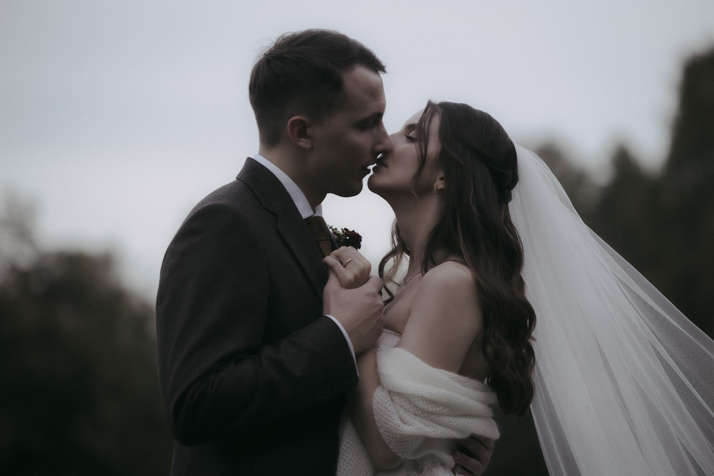 A romantic wedding couple shares intimate moments in a series of black and white photographs outdoors.