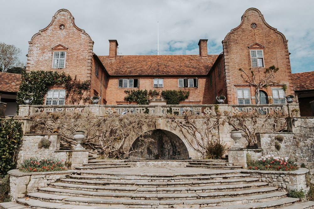 A panoramic view of a rustic brick garden terrace with stone steps and weathered architectural features.