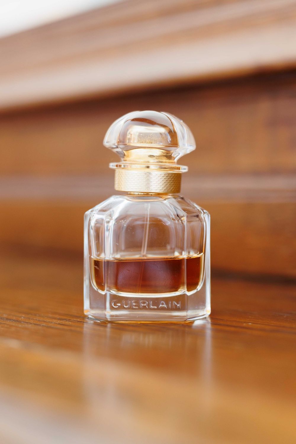 Crystal perfume bottles displayed on wooden surface with shallow depth of field.