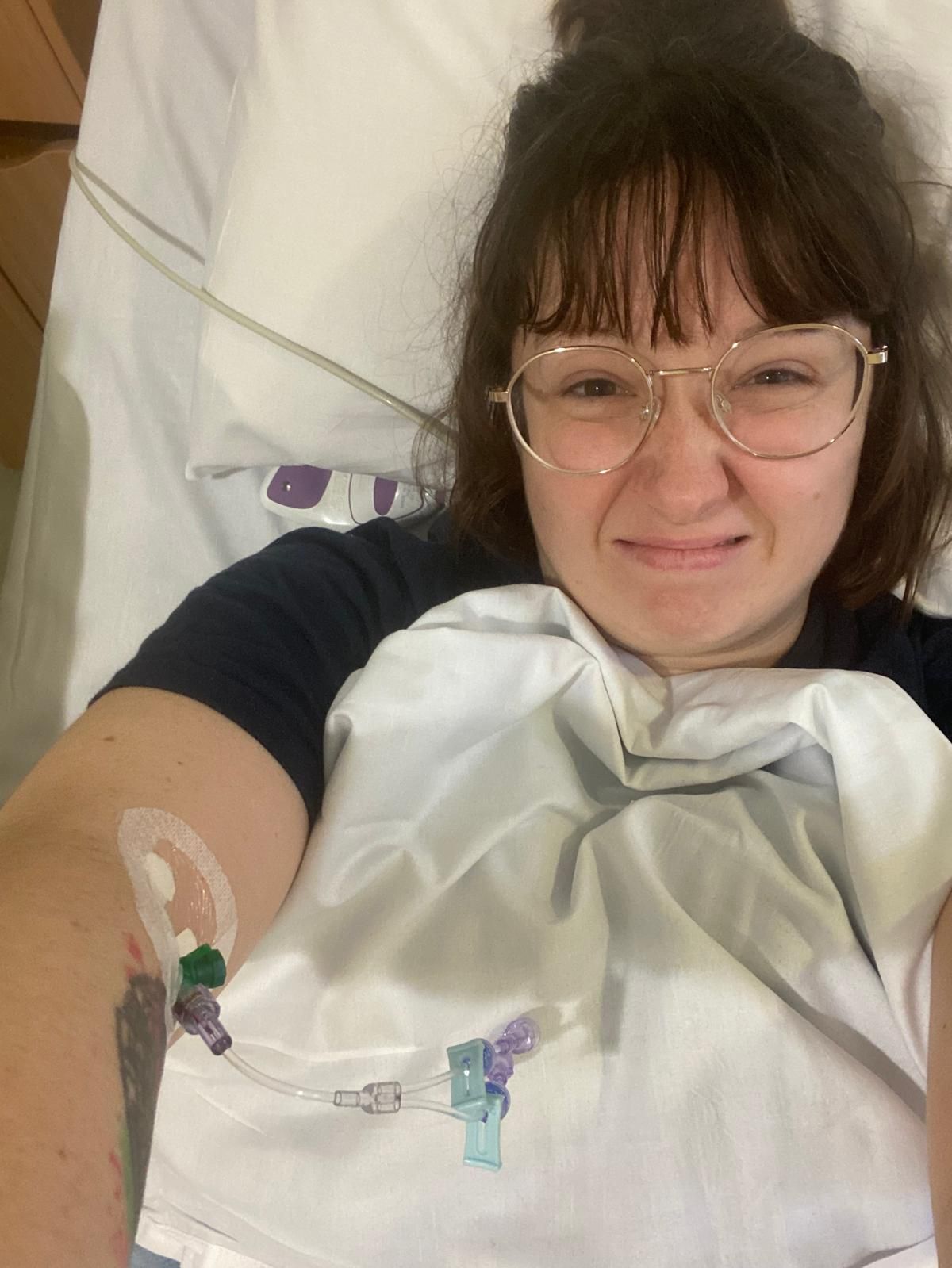 A series of selfies showing someone wearing glasses and a white blanket or hospital gown in bed.