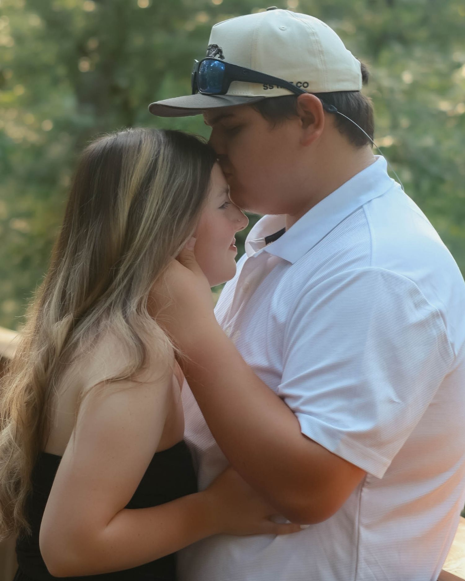 A romantic couple sharing an intimate moment together outdoors.