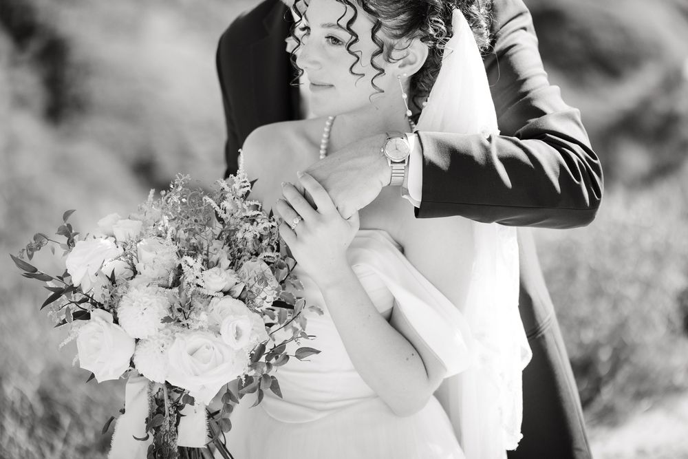 A black and white wedding photo collage showing intimate moments between the couple with floral bouquets and formal attire.