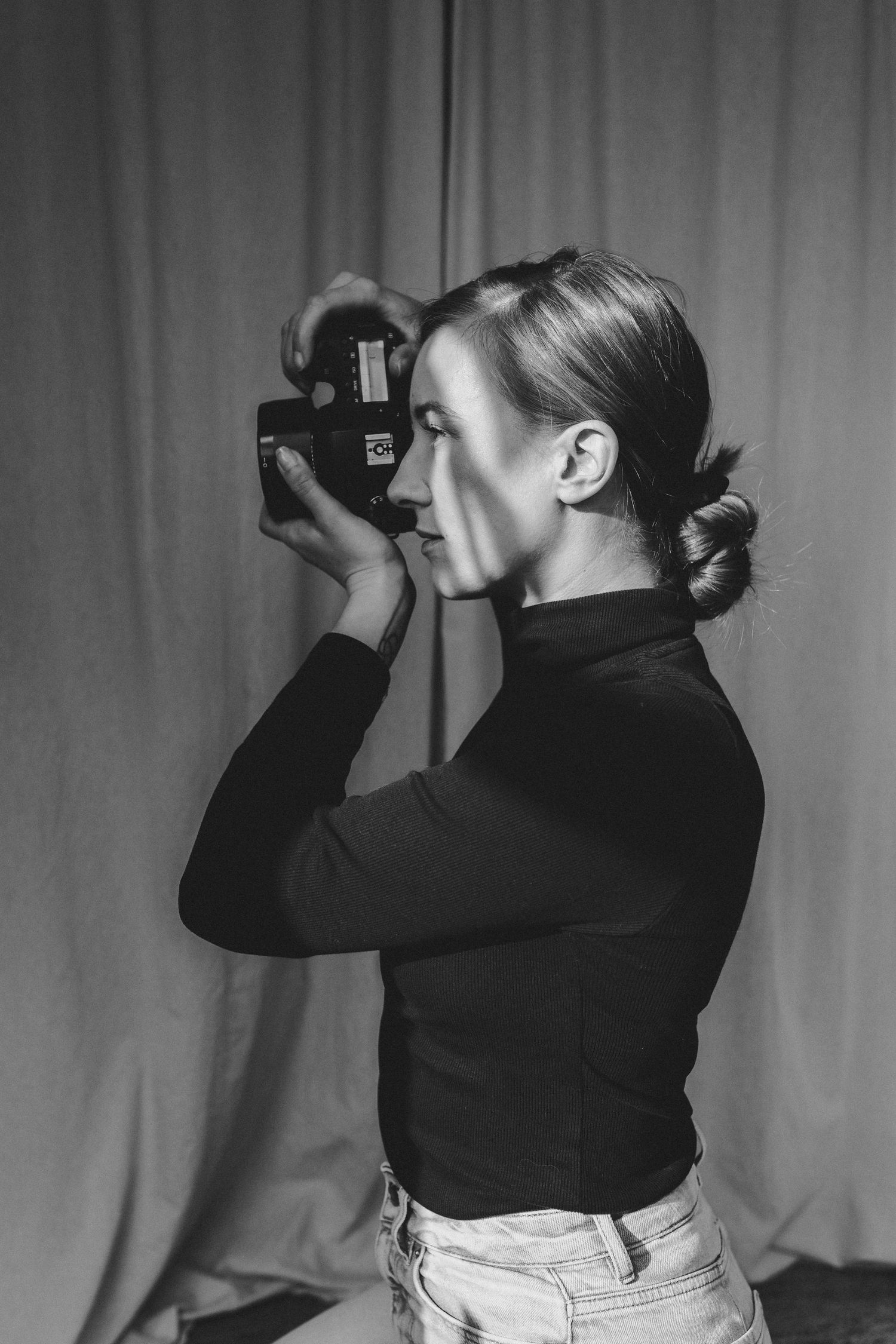 Paula Anna, Southampton photographer and memory keeper, holding her camera and ready to capture authentic family and wedding moments.