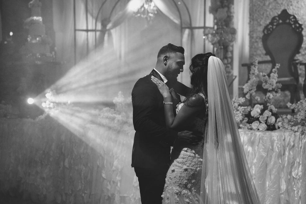A romantic black and white photo sequence shows a couple sharing their first dance at an elegant wedding reception.