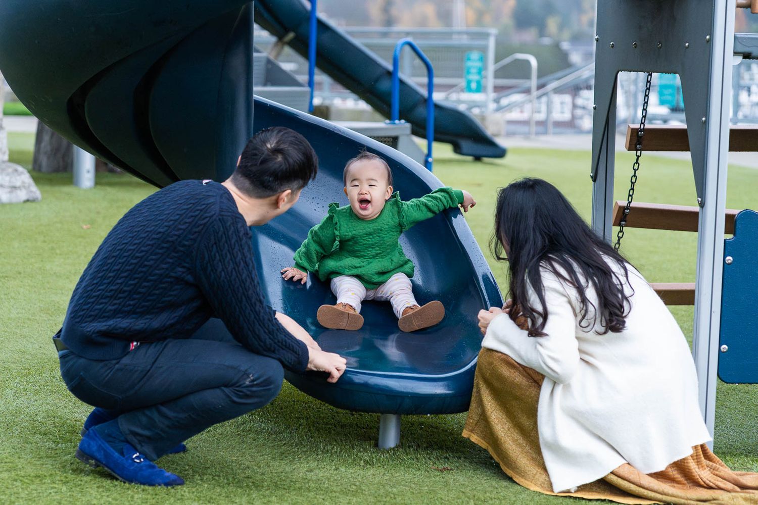 Baby laughing on the slide at the Bellevue playground.
