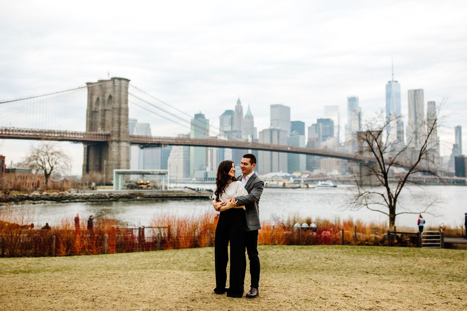 View of Manhattan skyline and bridges from a waterfront park in DUMBO Brooklyn.