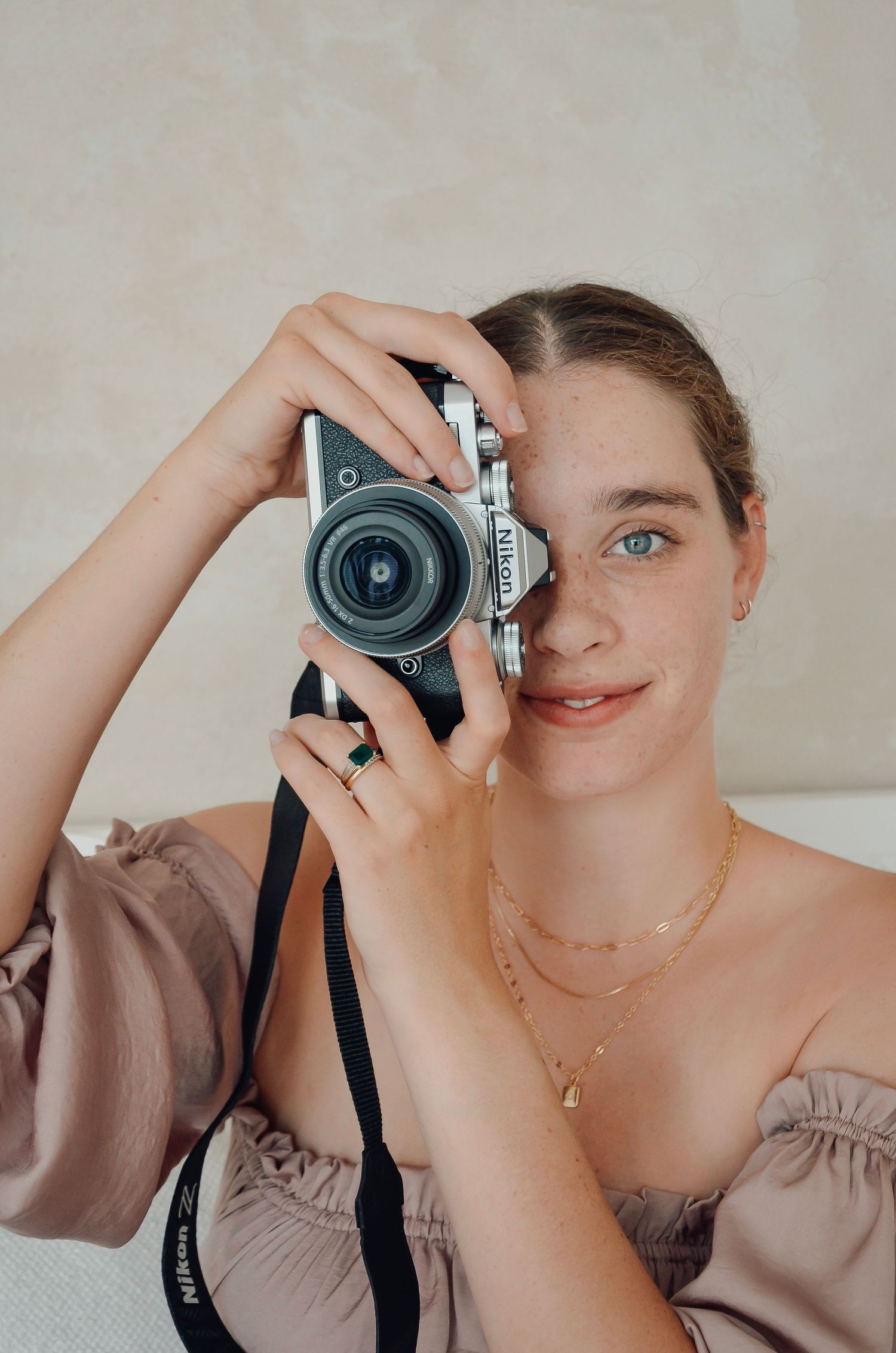 A photographer demonstrates different creative angles while taking self portraits with a vintage film camera.