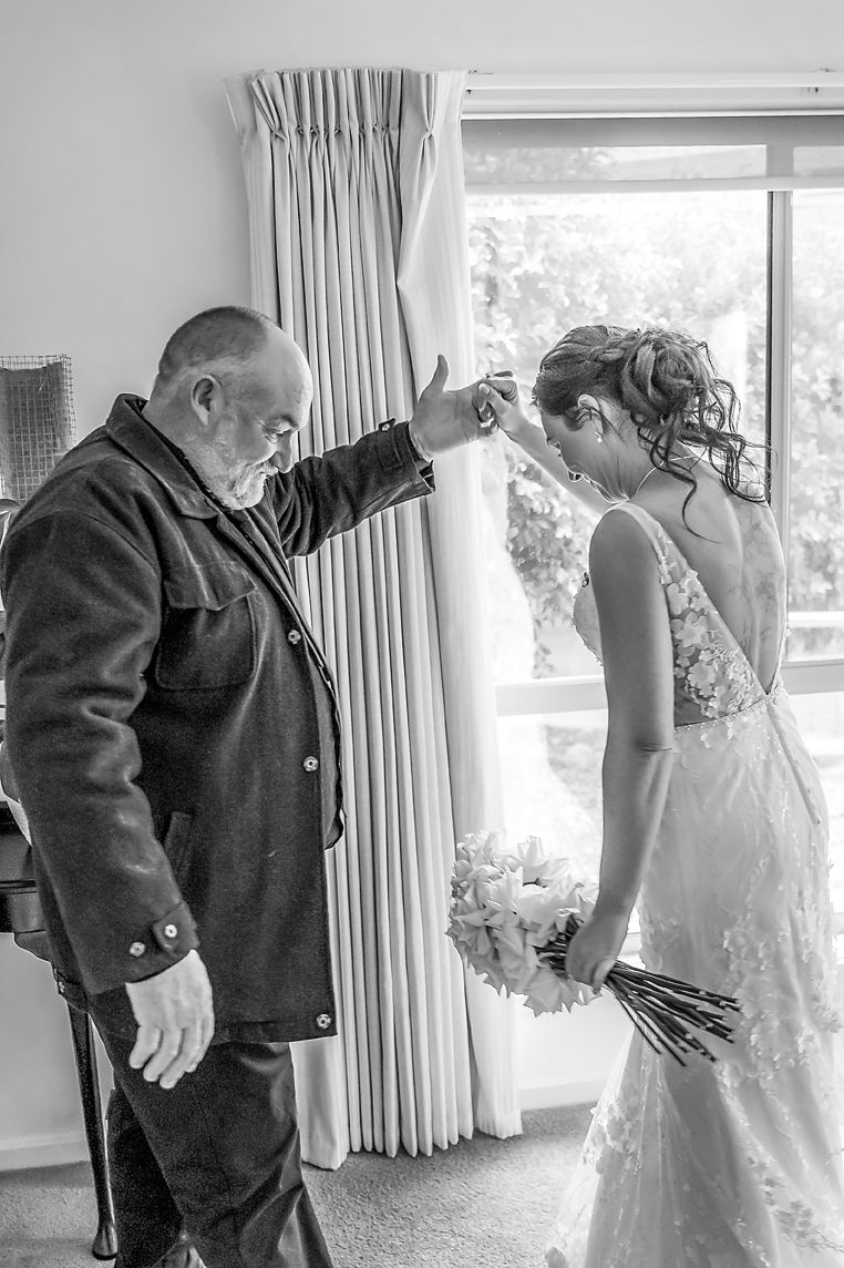 A sequence of black and white wedding photos showing emotional moments between people in formal attire.