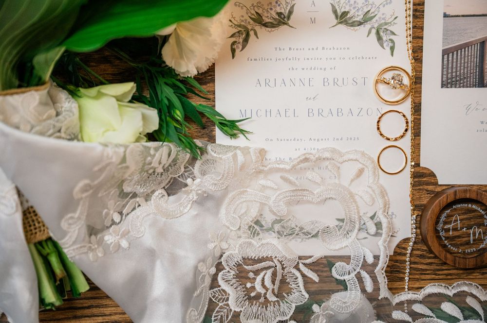 Wedding invitation suite with delicate lace details and floral elements.