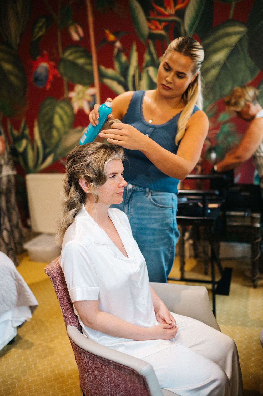A relaxing spa preparation scene shows someone receiving a head massage in a white robe.