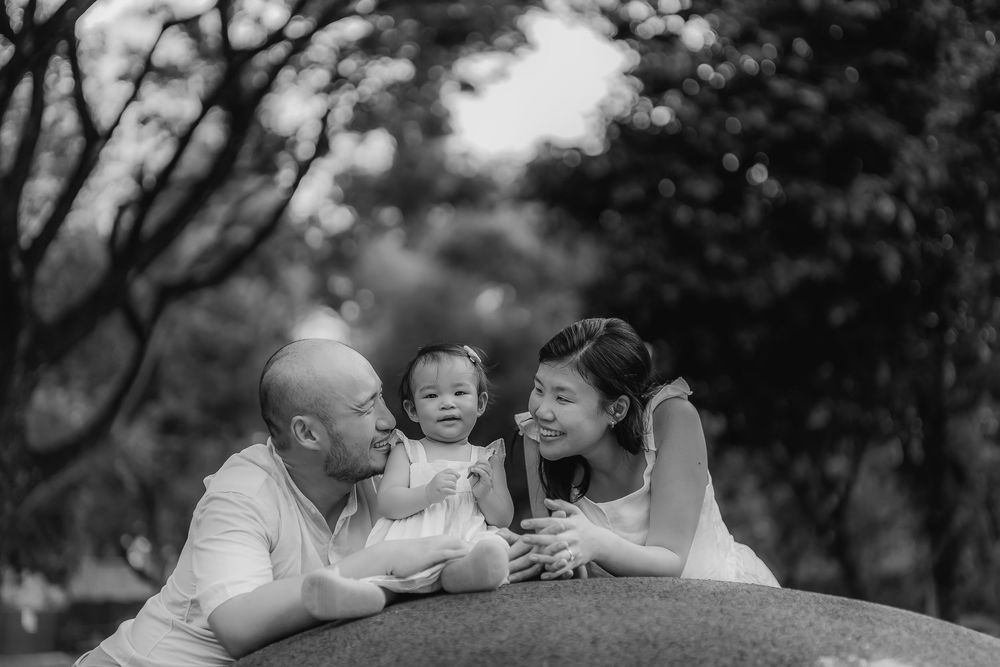 Black and white outdoor family portrait showing intimate moments.