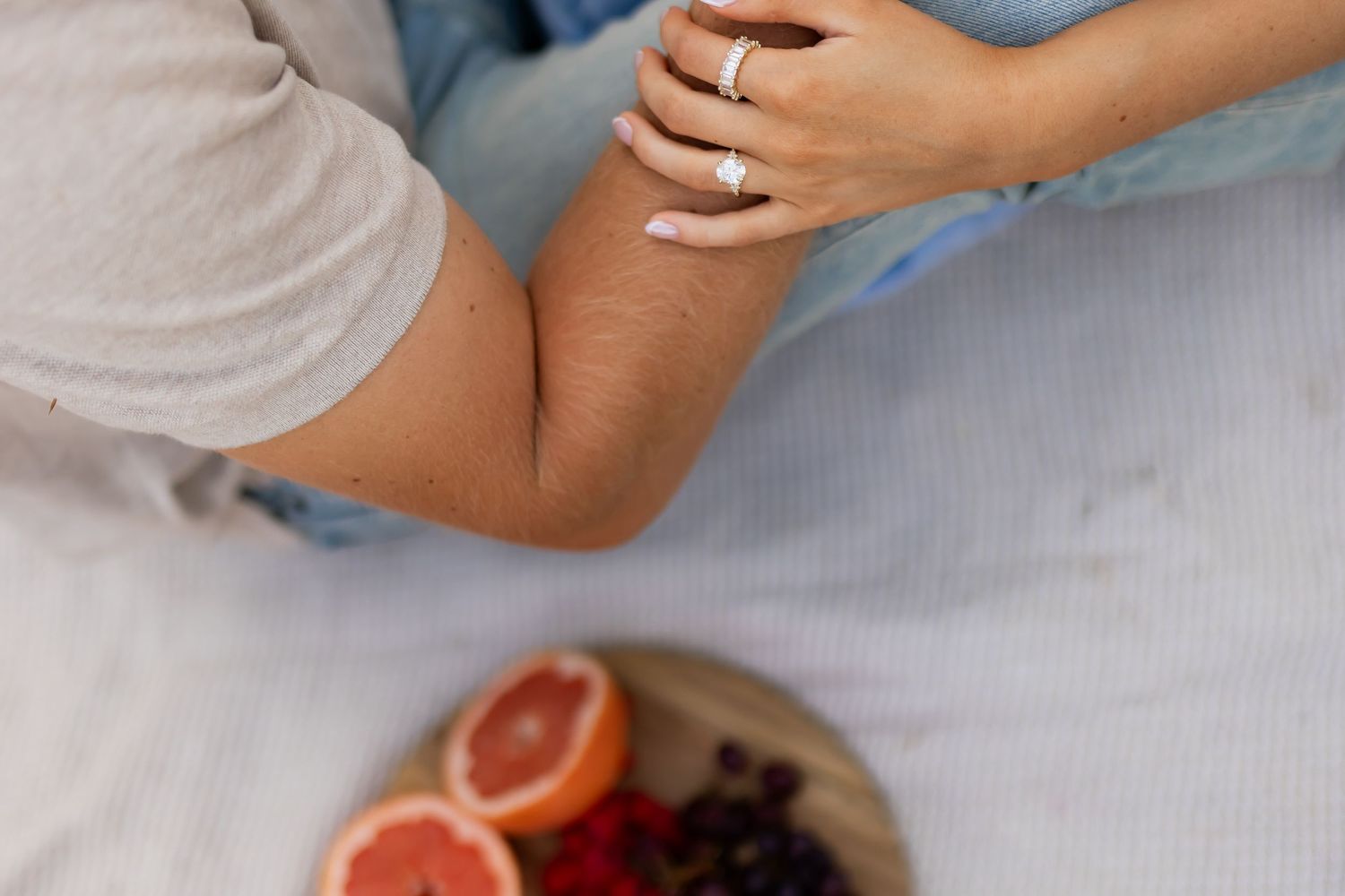 Close-up of engaged couple holding hands with engagement ring detail during a Utah couples photography session