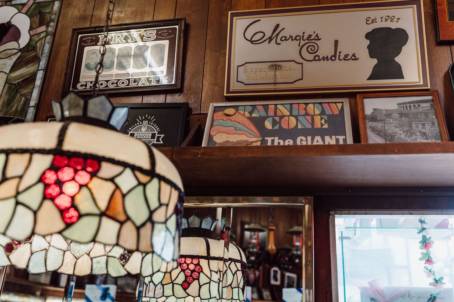 Vintage decorative stained glass lamps and signage adorn the walls of a retro bowling alley.