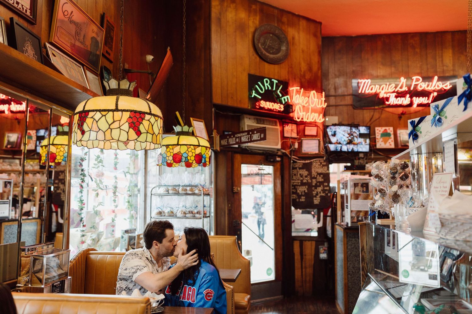 Interior view of retro diner with wood paneling and decorative lighting fixtures.