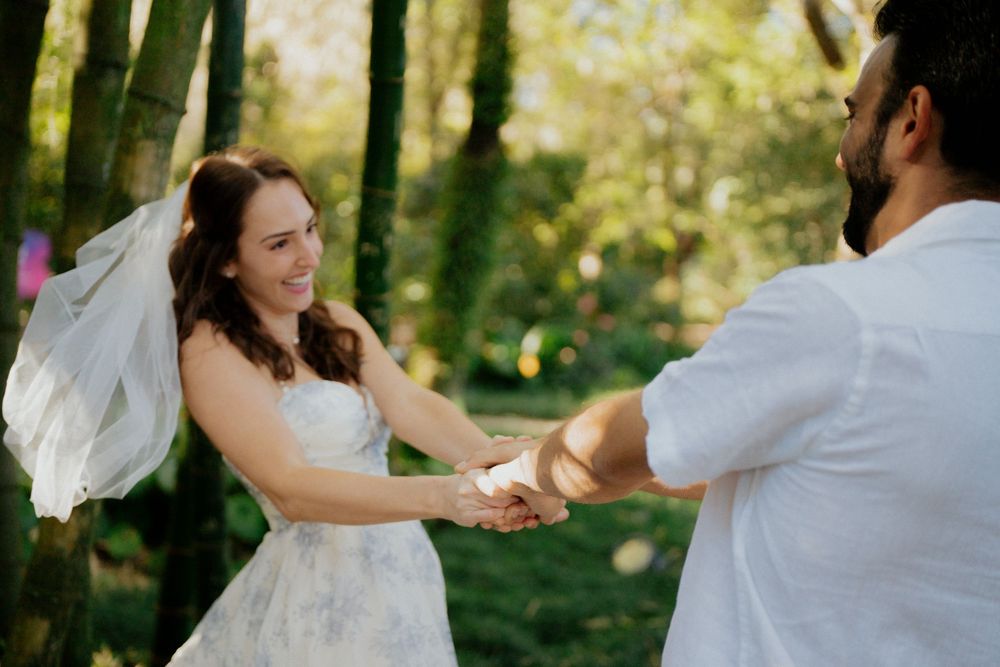 A joyful wedding couple dancing and laughing together  at Harry P Leu Gardens