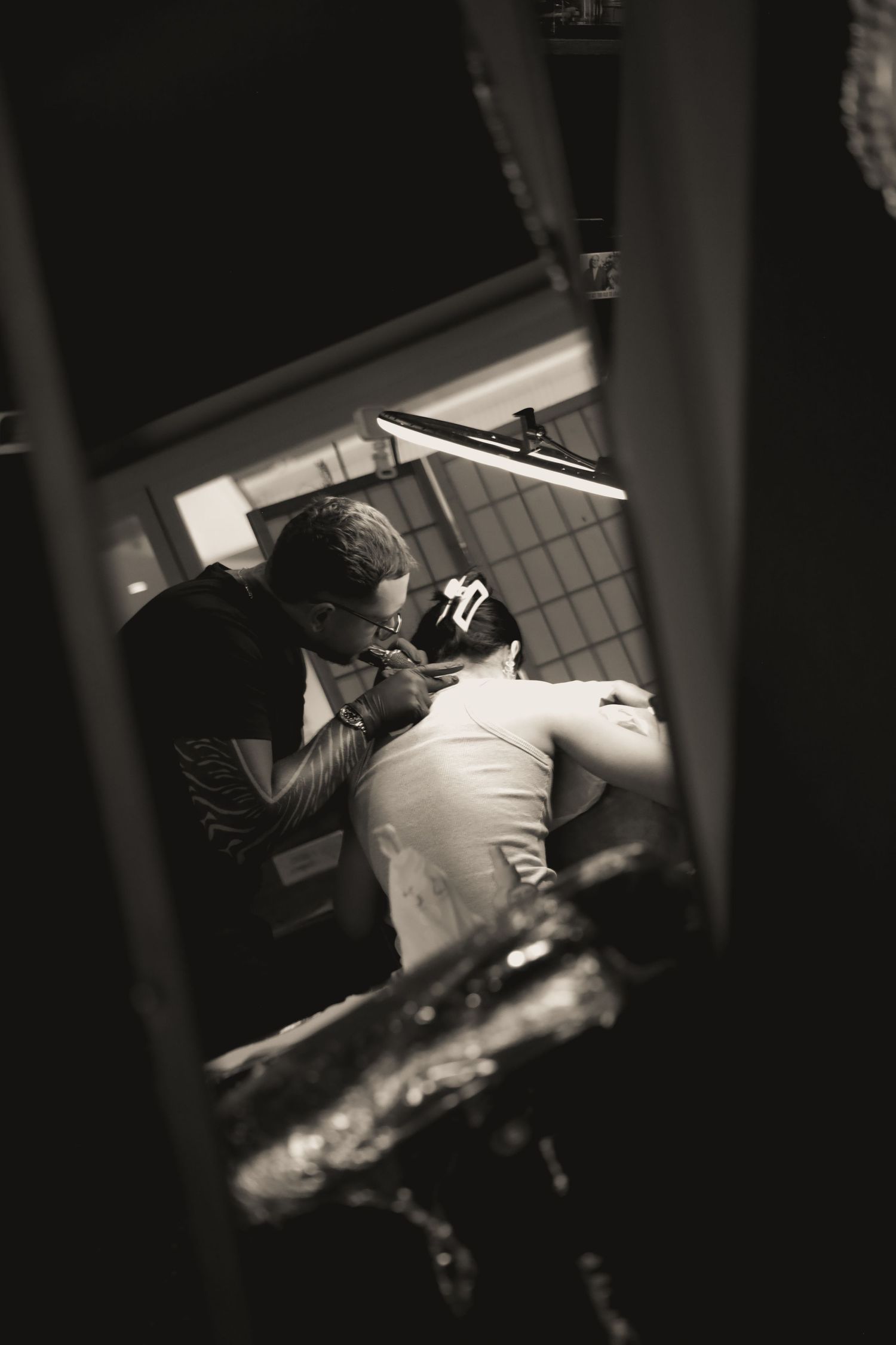 Two people embrace in a dimly lit room while dancing together during an intimate moment.