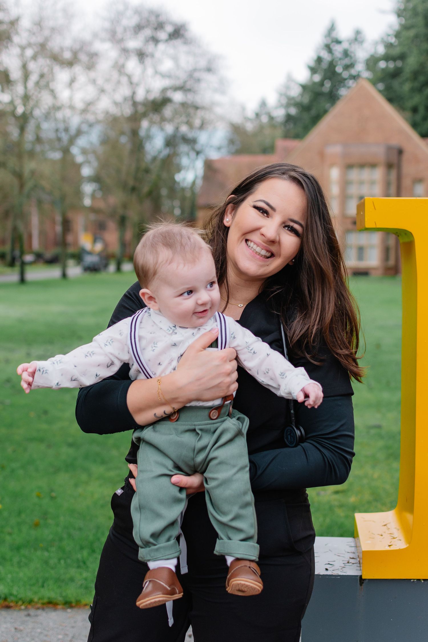 College graduation photos with a baby at Pacific Lutheran University in Tacoma, Washington.
