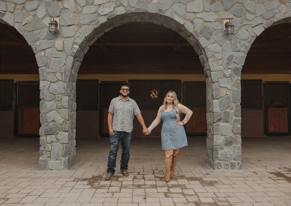 Family members stand in decreasing height order under stone archways.