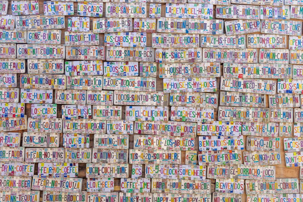 Overhead view of a large collection of colorful handwritten cardboard signs arranged in rows.
