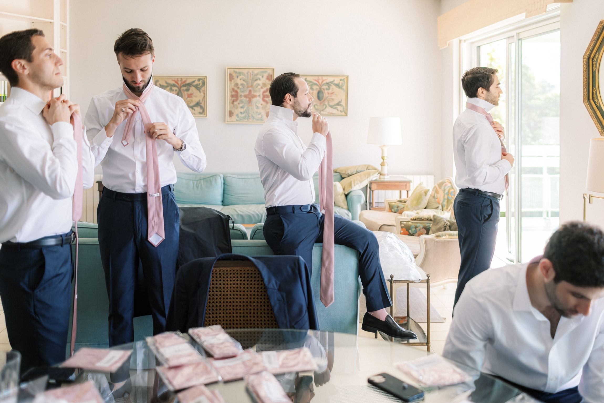 Groom and groomsmen wearing pink ties and socks matching bridal party wedding colors