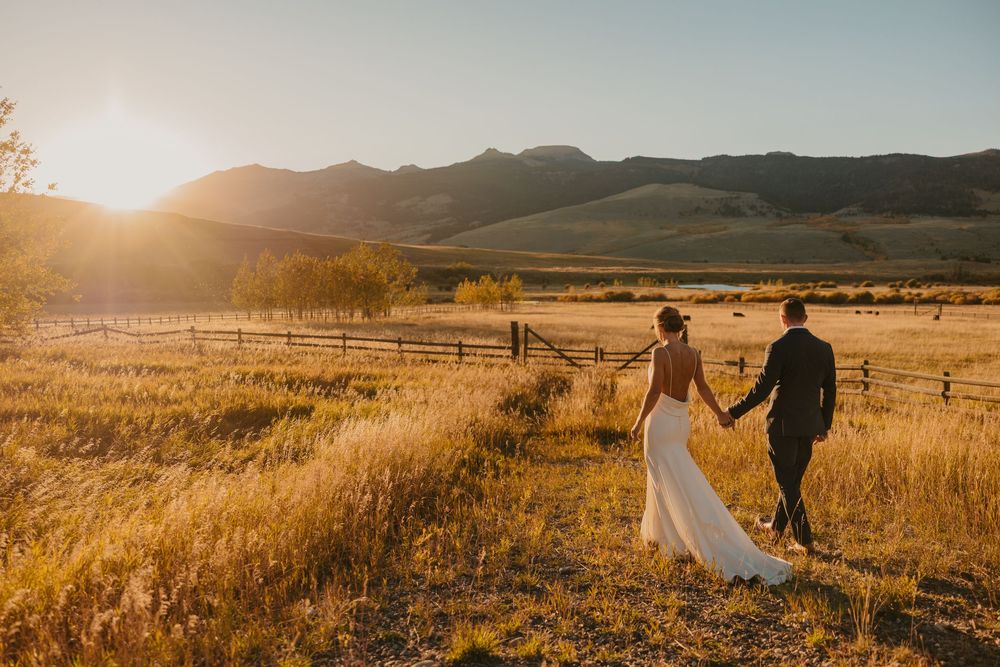 Groom leading bride in Mountains of Grizzly Creek Ranch Wedding in Emigrant Montana captured by Pray Montana Wedding Photographer