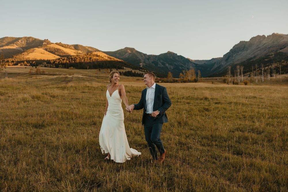 Groom leading bride in Mountains of Grizzly Creek Ranch Wedding in Emigrant Montana captured by Pray Montana Wedding Photographer