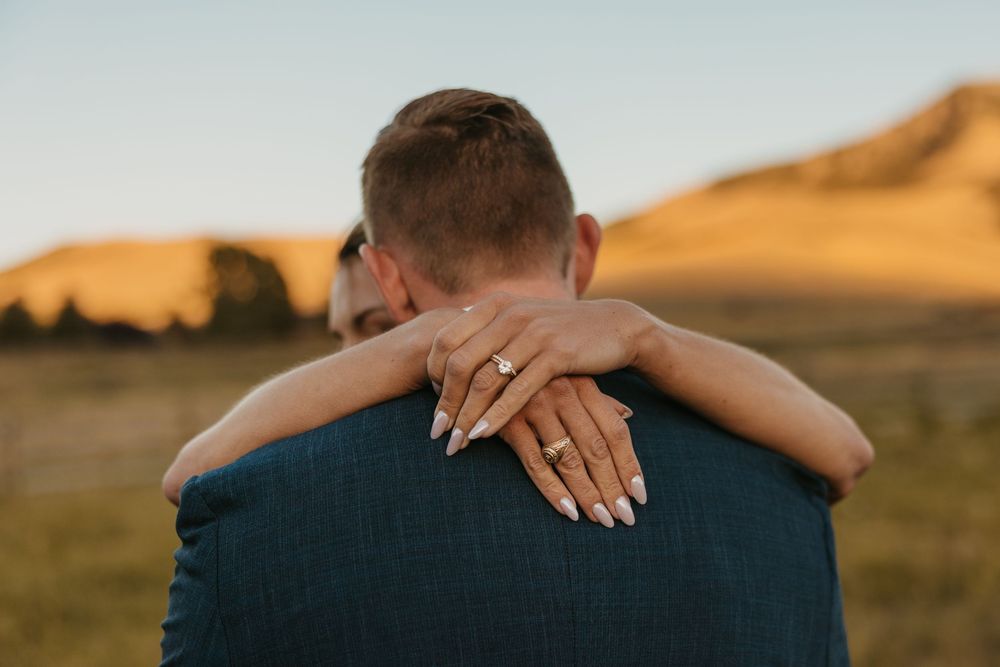 Mountains of Grizzly Creek Ranch Wedding in Emigrant Montana captured by Pray Montana Wedding Photographer as bride wraps around her groom