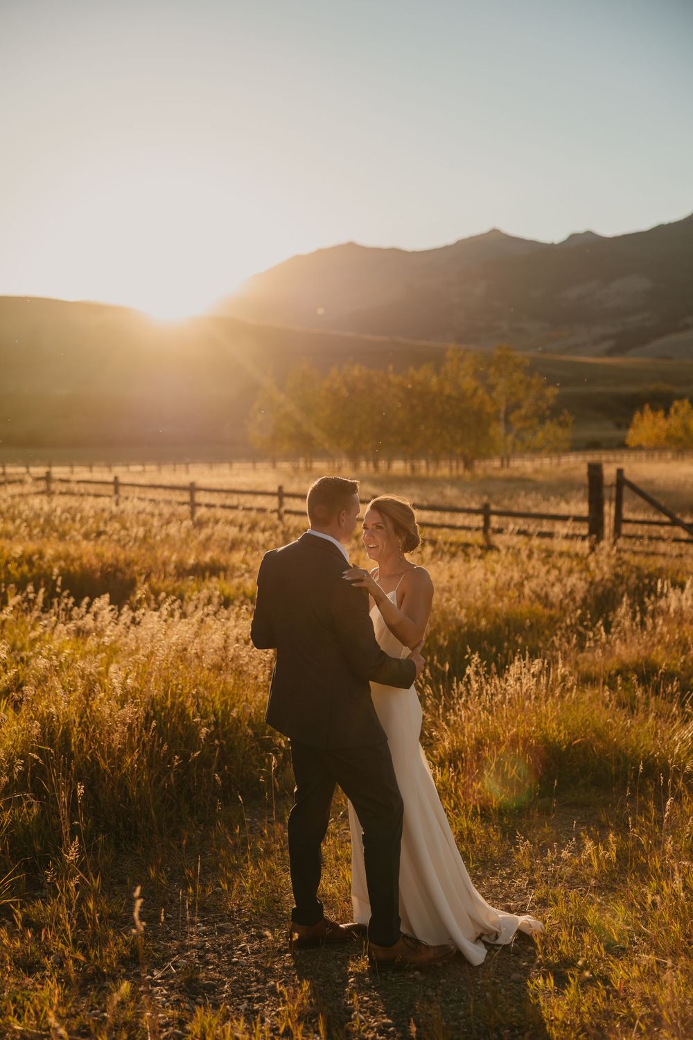 Couple embraces in Mountains of Grizzly Creek Ranch Wedding in Emigrant Montana at sunset captured by Pray Montana Wedding Photographer