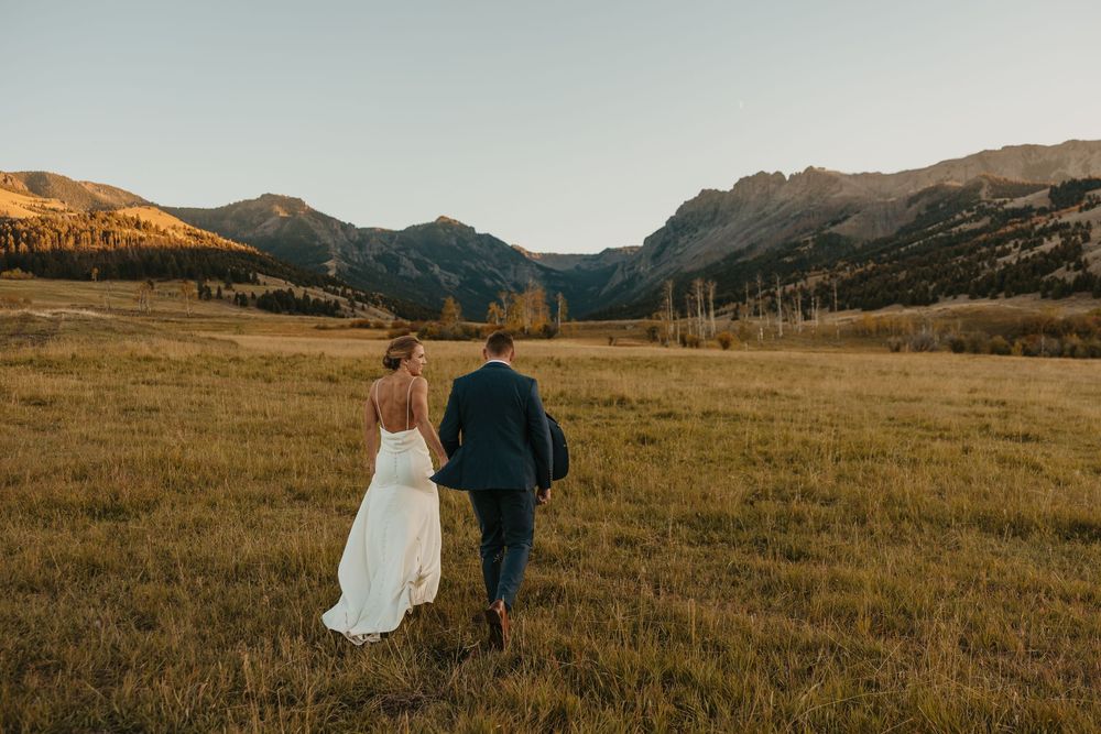 Groom leading bride in Mountains of Grizzly Creek Ranch Wedding in Emigrant Montana captured by Pray Montana Wedding Photographer