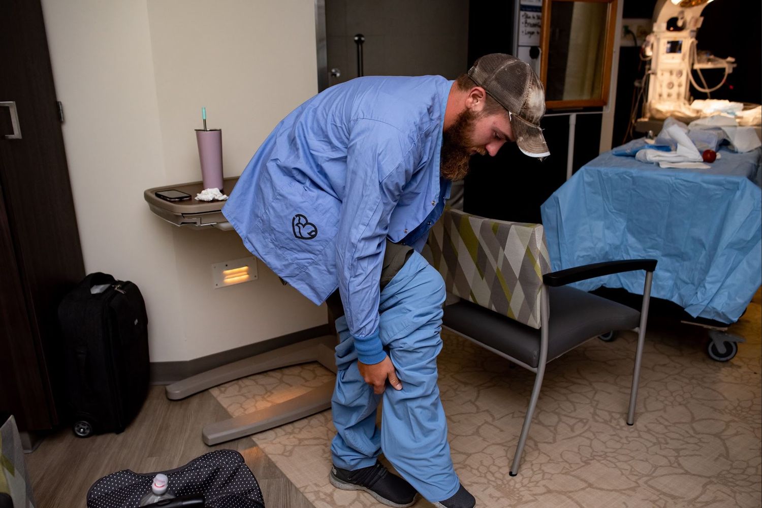 A new dad puts on scrubs to go into the OR for a c-section with his partner