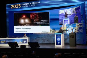 2025 Diggers and Dealers Mining Forum presentation stage with speaker at podium.